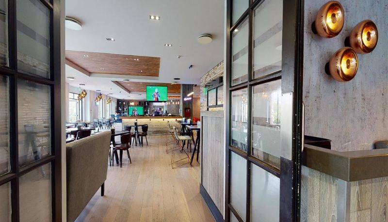 Village Hotel St Davids - lounge and entrance with copper lighting, looking through to the bar