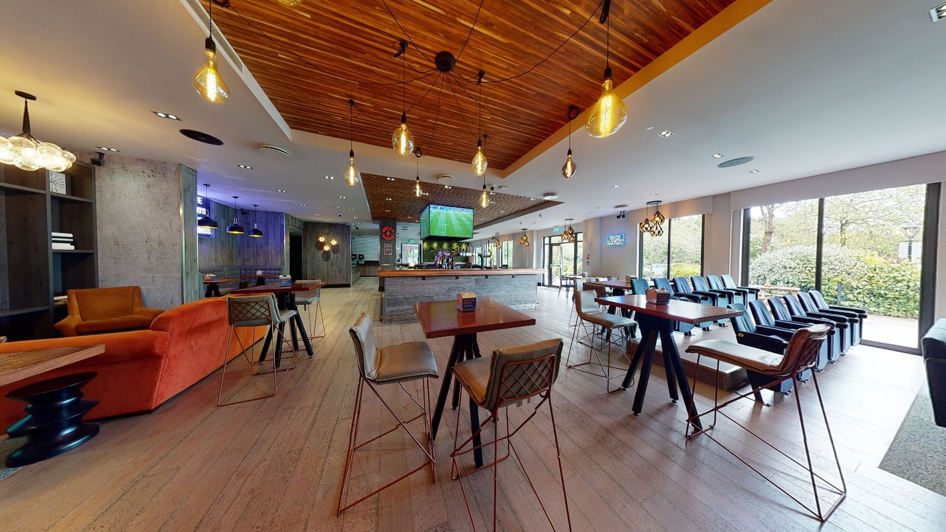 The bar and lounge at Village Hotel St Davids, Ewloe - exposed-wood ceiling, high tables and big windows